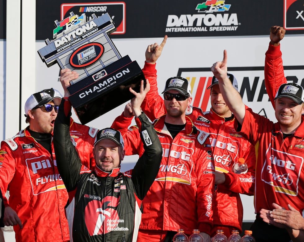 Former NASCAR driver Michael Annett (holding trophy) earned his only career win at Daytona in...