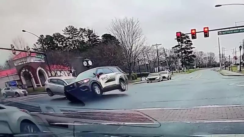 Shot from dashcam footage shows Mint Hill police car and another driver collide, sending the...